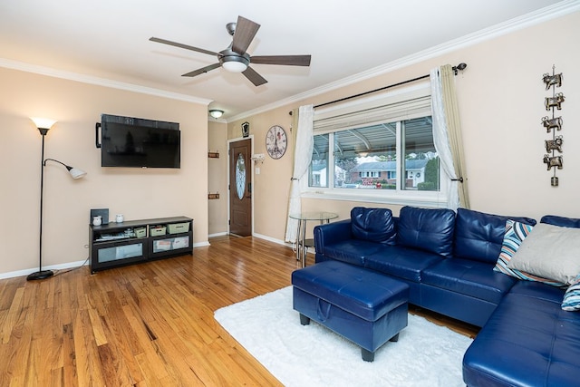 living room featuring ornamental molding, ceiling fan, and wood-type flooring