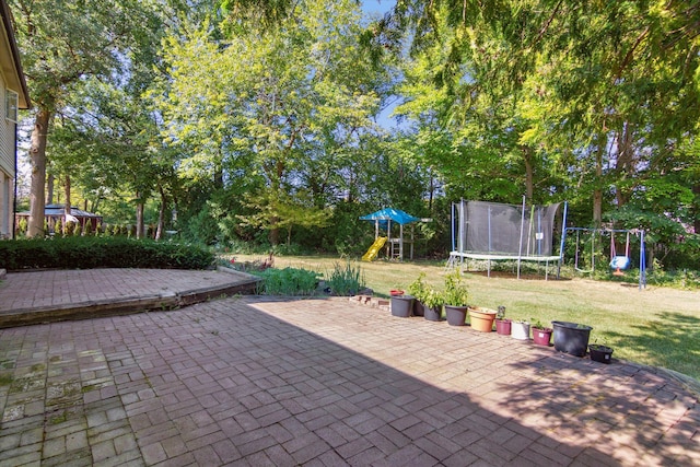 view of patio featuring a playground and a trampoline