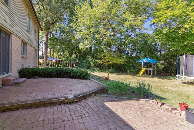 view of patio featuring a playground and a trampoline