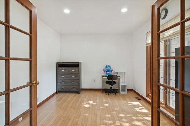 unfurnished office featuring light wood-type flooring