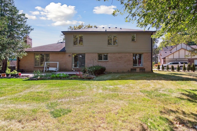 rear view of property featuring a yard and a patio area