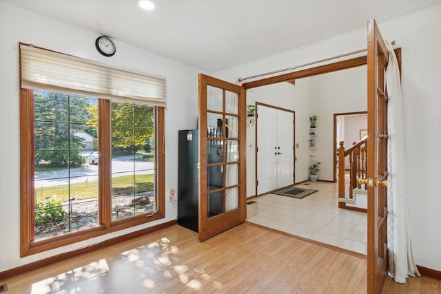 doorway to outside with french doors and light hardwood / wood-style flooring