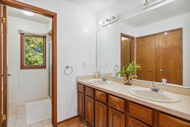 bathroom with vanity and a shower with shower door