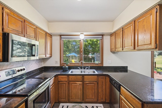 kitchen featuring kitchen peninsula, sink, and appliances with stainless steel finishes