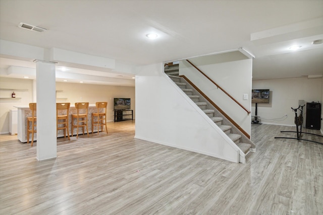 basement with light hardwood / wood-style floors