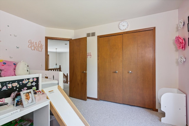 carpeted bedroom with a closet