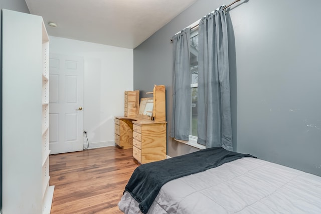 bedroom with hardwood / wood-style floors