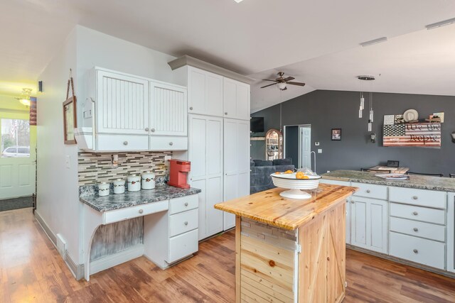 1385 Wetheral Lake Dr, Martin, MI 49070 - kitchen with a ceiling fan, light wood-type flooring, white cabinetry, decorative backsplash, and vaulted ceiling