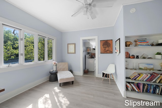 sitting room with ceiling fan, light hardwood / wood-style floors, and ornamental molding