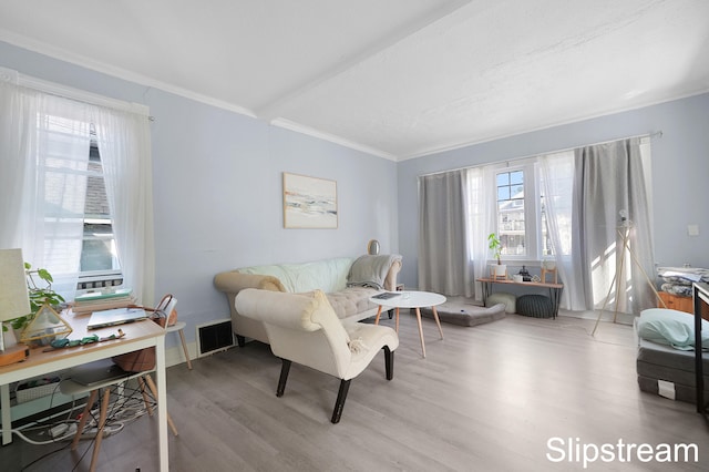 living room with light hardwood / wood-style floors and ornamental molding