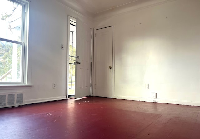 foyer with dark hardwood / wood-style flooring and crown molding