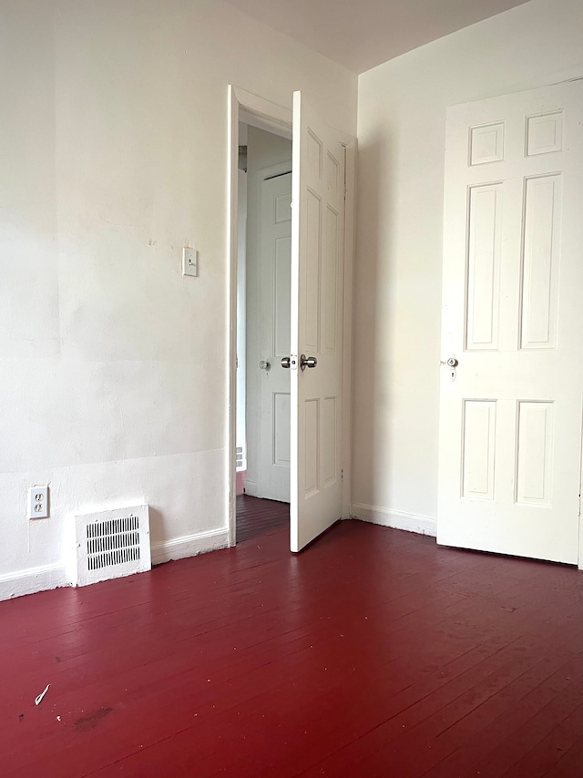 unfurnished bedroom featuring dark hardwood / wood-style floors