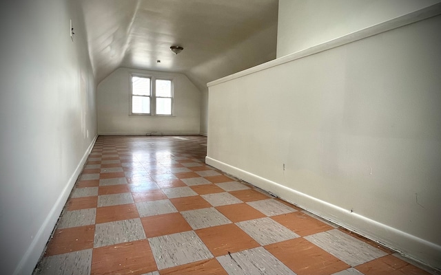 additional living space featuring vaulted ceiling