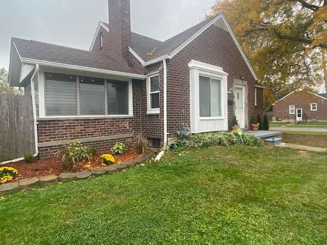 view of side of home with a yard