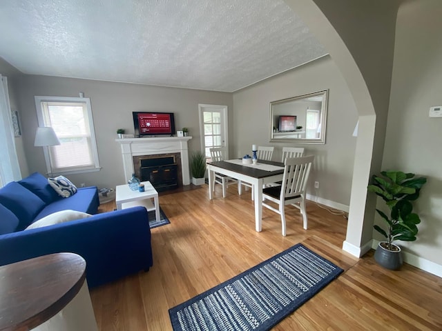 living room with wood-type flooring and a textured ceiling