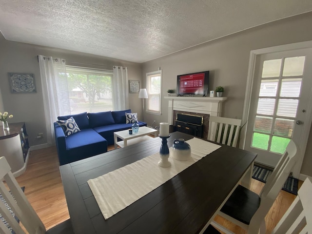 living room featuring a fireplace, hardwood / wood-style floors, and a textured ceiling