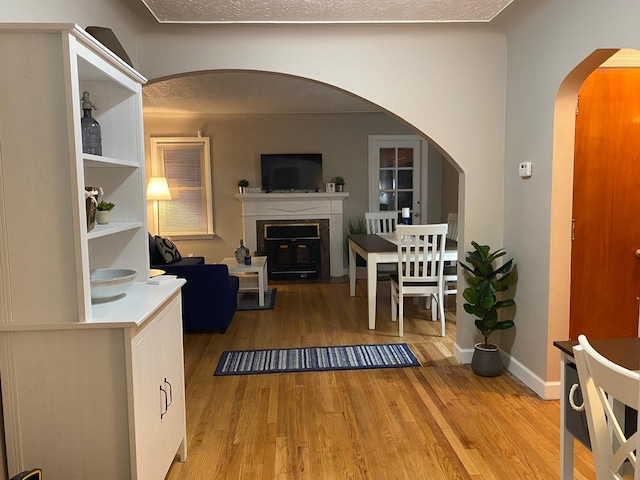 living room with hardwood / wood-style floors and a textured ceiling