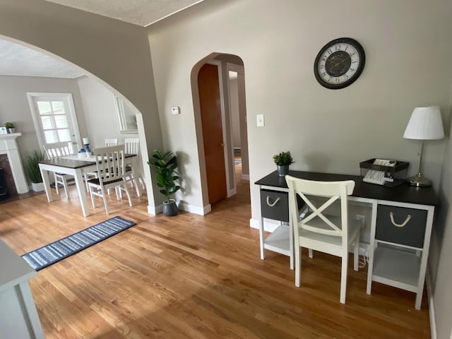 dining area with a textured ceiling and hardwood / wood-style flooring