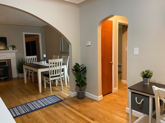 dining room featuring a textured ceiling and light hardwood / wood-style flooring