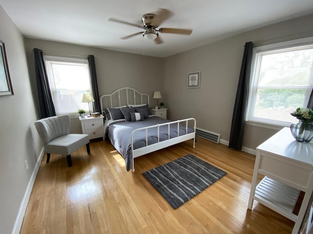 bedroom with light hardwood / wood-style flooring and ceiling fan