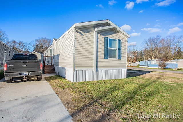 view of side of home with a yard