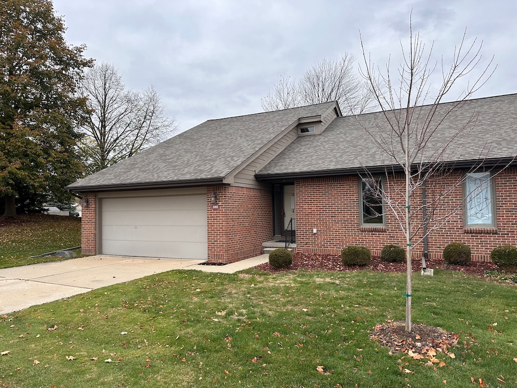 ranch-style home featuring a garage and a front yard