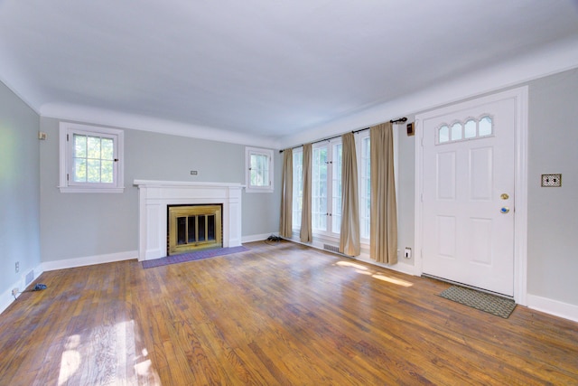 unfurnished living room featuring dark wood-type flooring