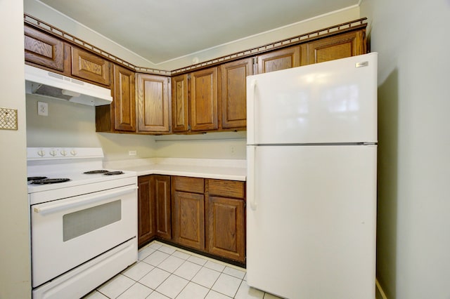 kitchen featuring light tile patterned flooring and white appliances