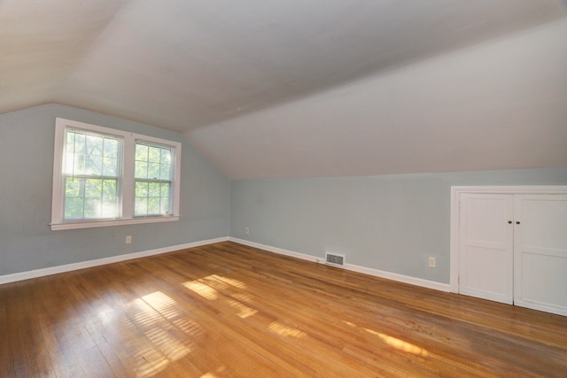 bonus room featuring wood-type flooring and lofted ceiling