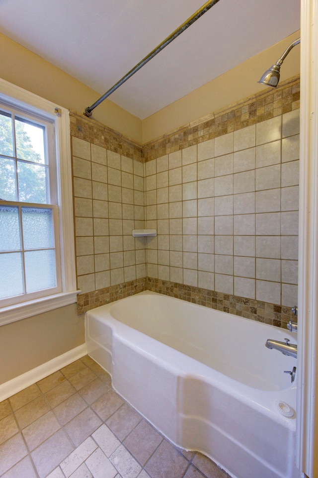 bathroom featuring tile patterned floors and tiled shower / bath