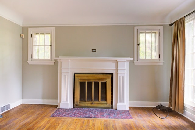 room details with hardwood / wood-style flooring and crown molding