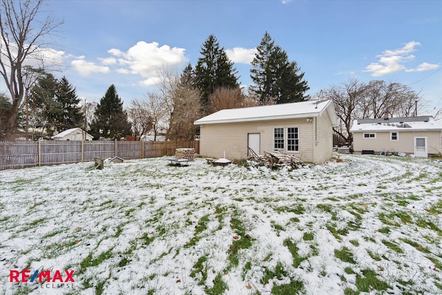 yard layered in snow featuring an outdoor structure