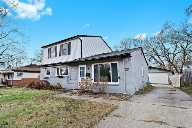 view of front property with a garage, an outbuilding, and a front yard