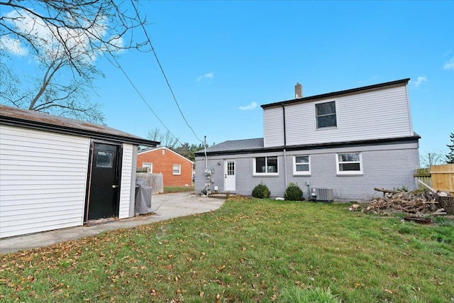 back of house with a yard and cooling unit