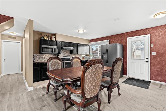 dining room with light wood-type flooring