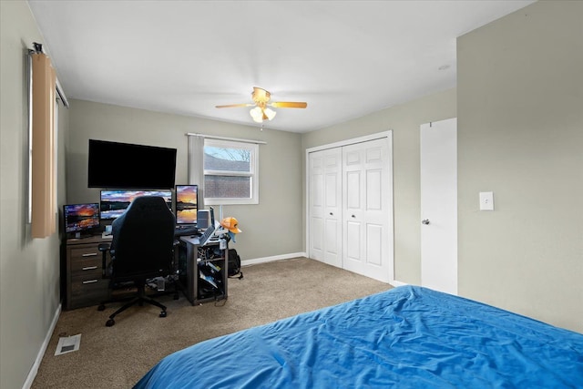 carpeted bedroom with ceiling fan and a closet