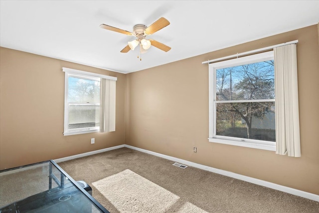 carpeted empty room with ceiling fan