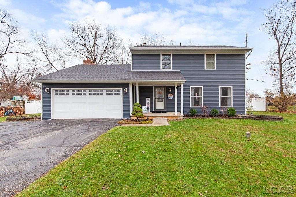 view of front property with a front lawn and a garage