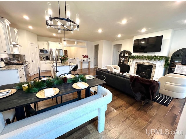 dining area featuring dark hardwood / wood-style flooring and an inviting chandelier