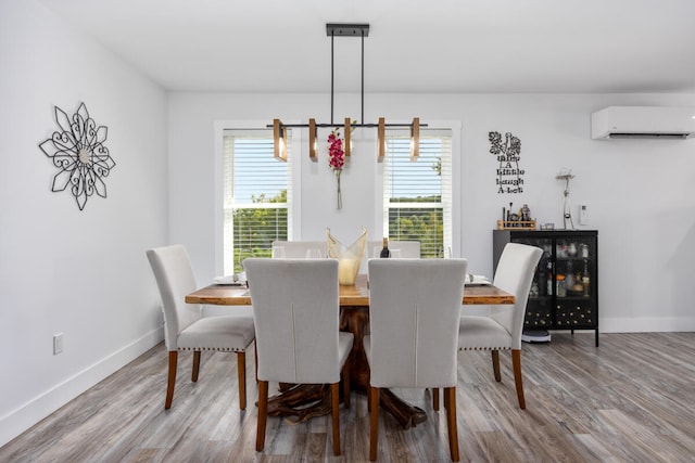 dining space with hardwood / wood-style flooring and a wall unit AC