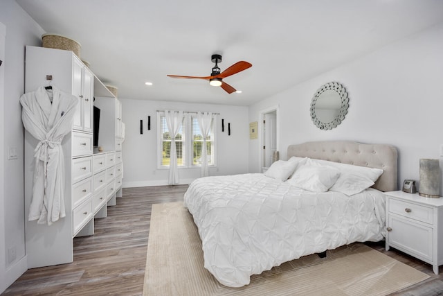 bedroom with hardwood / wood-style floors and ceiling fan