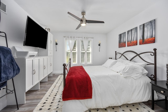 bedroom with ceiling fan and dark hardwood / wood-style floors