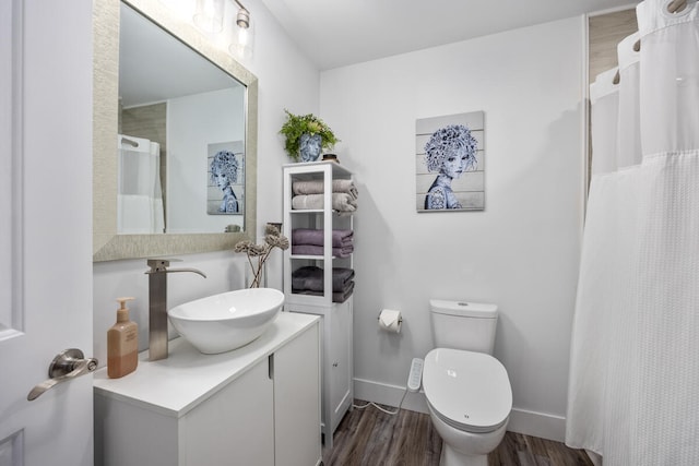 bathroom featuring vanity, hardwood / wood-style floors, toilet, and a shower with shower curtain