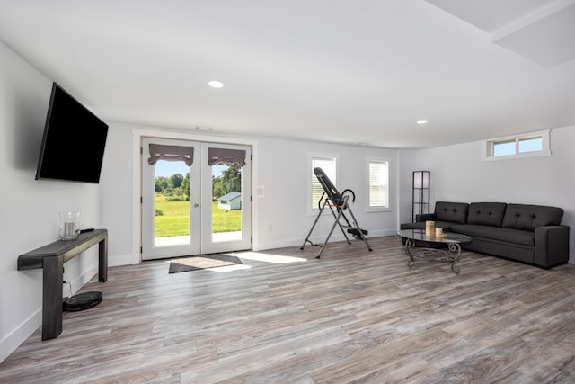 living room with light wood-type flooring and french doors