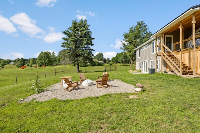 view of yard featuring a rural view and a fire pit