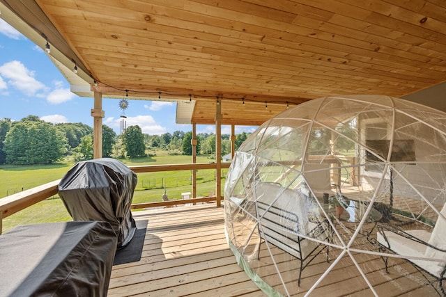 wooden deck featuring a lawn