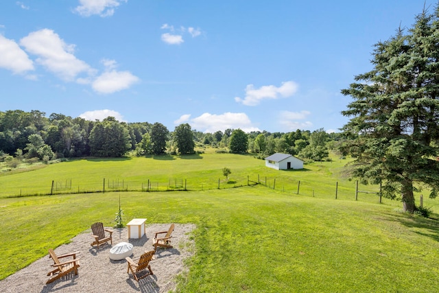 view of yard with a rural view and a fire pit