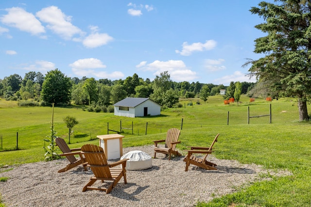 view of yard featuring a rural view and an outdoor fire pit