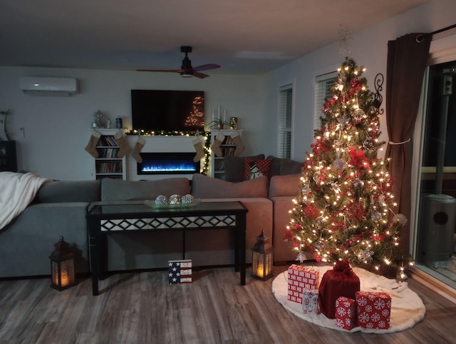 living room with ceiling fan, hardwood / wood-style floors, and a wall unit AC