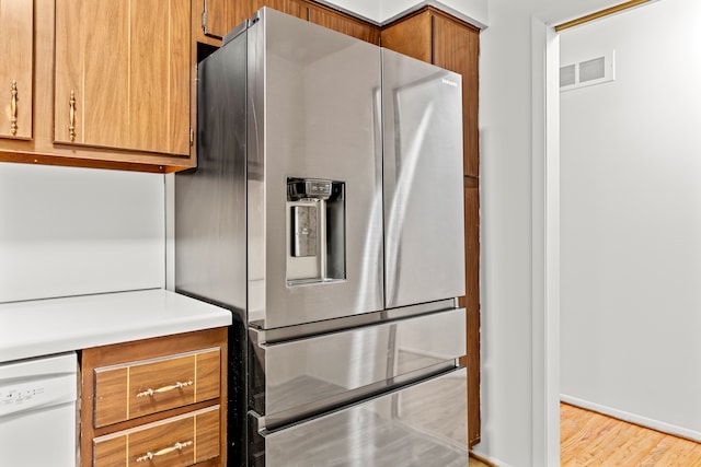 kitchen with dishwasher, stainless steel refrigerator with ice dispenser, and light hardwood / wood-style floors